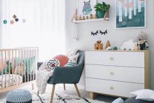 a bright contemporary nursery in white with touches of muted colors here and there is very welcoming and chic