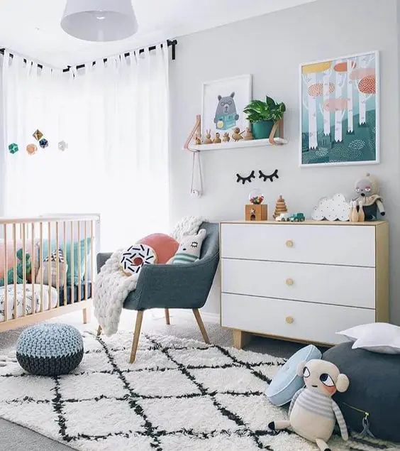 a bright contemporary nursery in white with touches of muted colors here and there is very welcoming and chic