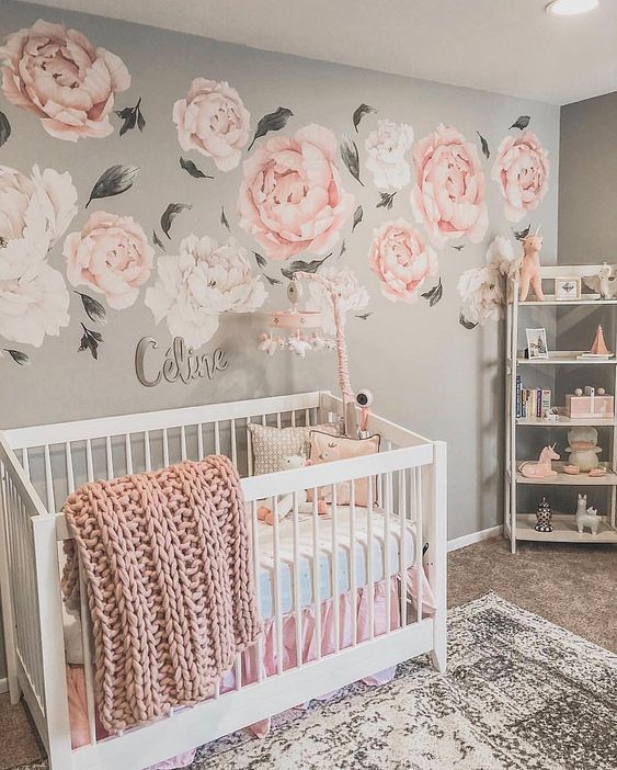 a chic girl’s nursery with a pink floral mural, grey walls, white furniture and touches of pink here and there