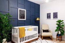 a chic nursery with a navy 3D wall and a navy planter to spice up the neutral space and makes it cooler