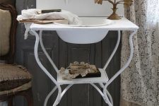 a creative and chic metal sink stand with a tiny shelf is a lovely idea for a vintage, shabby chic or rustic space, it looks very nice
