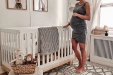 a gender neutral nursery with bunny artworks, a woven rug and ottoman on wooden legs is ultimate cuteness and chic