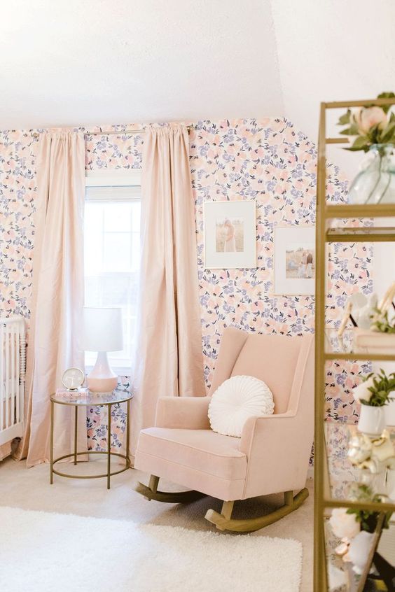 a girlish nursery with a floral wall, a blush rocker, blush curtains and gilded touches is a cool idea