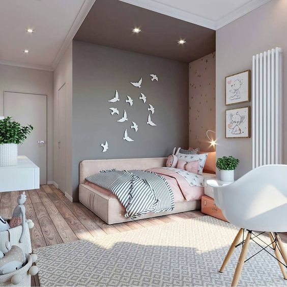a lovely pink and grey teen girl bedroom with a bed in an alcove, bird art, potted greenery and cute artworks