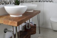 a lovely rustic bathroom vanity made of a hairpin leg table, with baskets for storage is a perfect idea for a rustic or farmhouse space