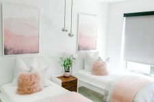 a lovely shared girls’ bedroom with white beds and a stained nightstand, pink and neutral textiles, pink artworks