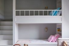 a minimalist shared girls’ bedroom with bunk beds and built-in shelves, a sofa by the window and bright printed textiles