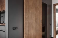 a minimalist wooden sliding door matches the interior and keeps the space laconic at the same time