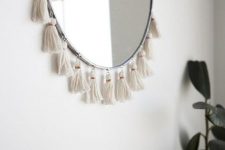a semi circle mirror with tassels is a fantastic solution for a boho space, it will add a cool wild touch to the room