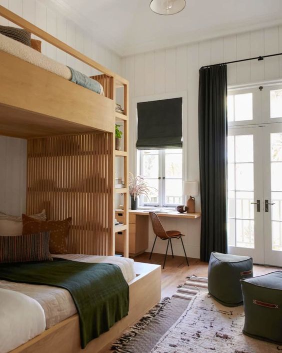 a stylish modern farmhouse shared teen bedroom with a plywood bunk bed, a desk, green ottomans and textiles