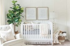 a welcoming white nursery with a wicker lampshade, a knit and fur rug, a white chair and baskets for storage