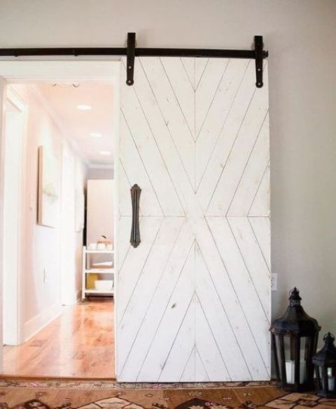 A white sliding vintage inspired barn door for a rustic and vintage touch