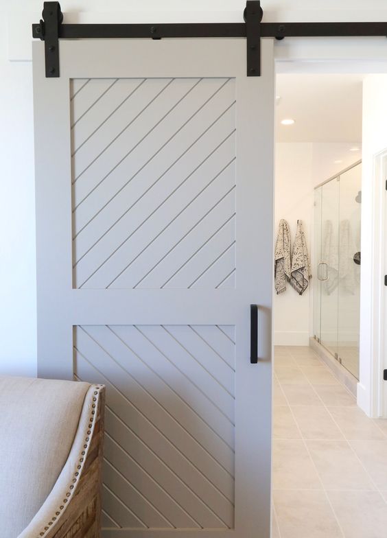 a whitewashed sliding barn door with black touches will add a rustic touch but a stylized one