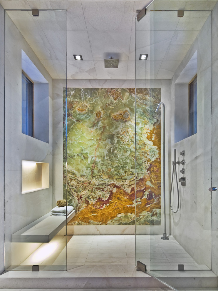 A marble walk-in shower with a wall that looks like a piece of art. (186 Lighting Design Group - Gregg Mackell)