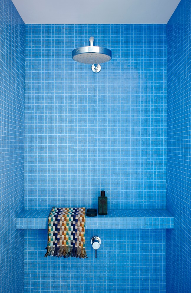 A minimalist shower covered only with blue mosaic tiles. (Scott Weston Architecture Design PL)