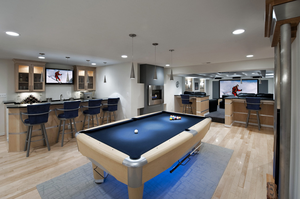 the whole basement here is turned into man's heaven with a pool table, a TV area and a bar (Moss Building and Design | Moss Home Services)