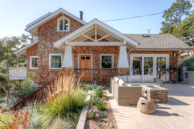 a craftsman style house with an amazing outdoor area and a porch covered with a gable roof leading to it