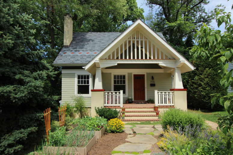 a small cottage with a beautiful front yard garden and a gable roof with gorgeous trim covering a porch (Bennett Frank McCarthy Architects, Inc.)