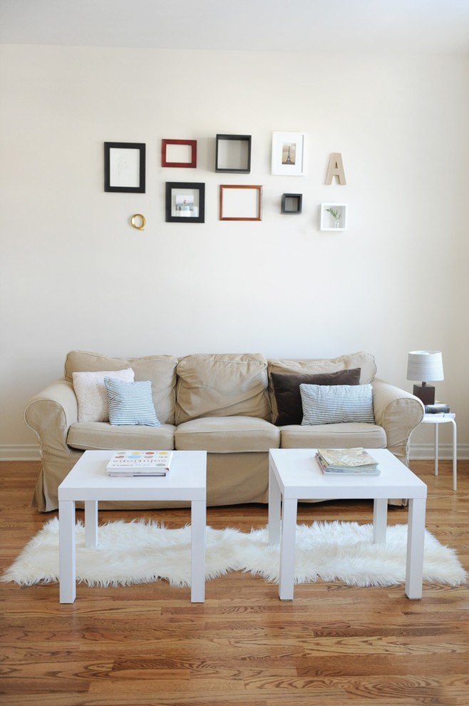 create a gallery wall above the sofa that complements its colors