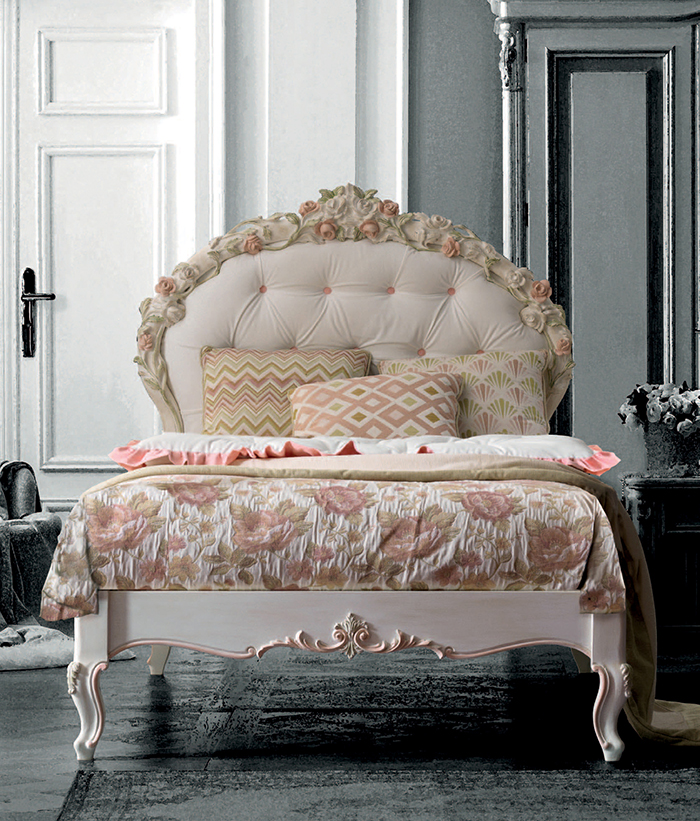 Luigina bed with a hand-carved floral headboard completed with floral bedding