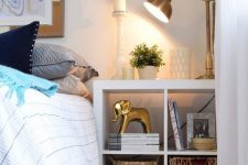 a simple white IKEA Kallax shelf as a functional nightstand that will provide you with a lot of storage space