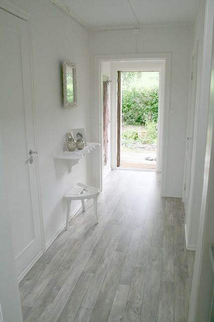 02 grey floors in the white hallway definitely give a light feeling to the room