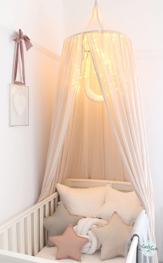 pastel crib cot with a LEDs canopy