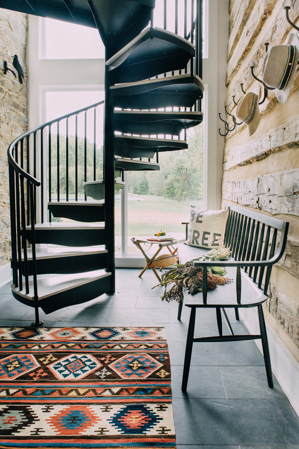 A blackened steel staircase in the hallway hints on other industrial touches in the home