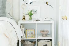 an IKEA Kallax unit as a nightstand, with plenty of storage space and some decor on and over the piece is a great solution for a bedroom