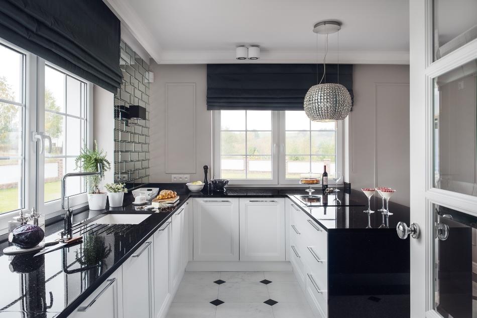 The kitchen cabinets are white with black granite countertops with a touch of glitter