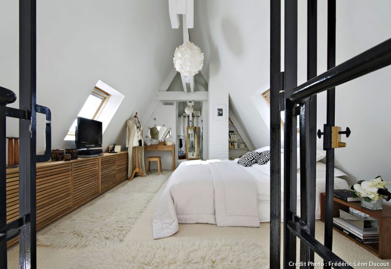 The bedroom decor was softened with the help of light-colored furniture of natural wood