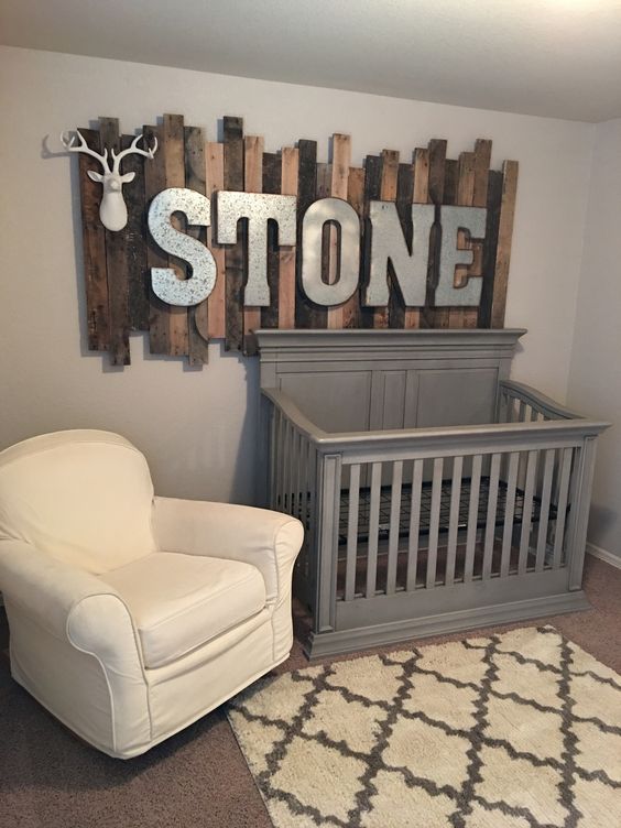04 rustic wood pallet sign with galvanized metal letters above the baby’s crib