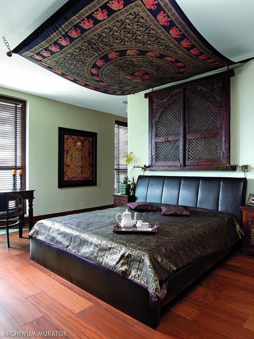 05 An original rug is hug as a canopy in the bedroom, and there’s a Nepal mandala on the wall