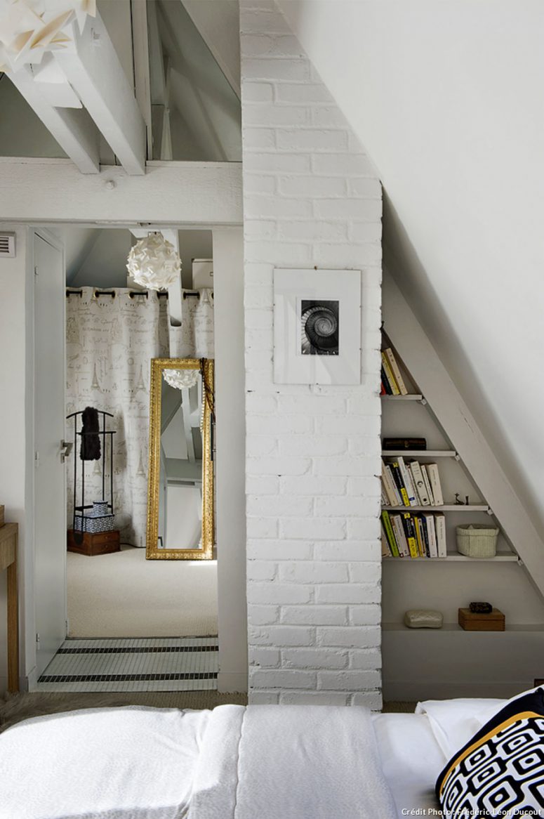 Elements of whitewashed brick clad give the bedroom a character