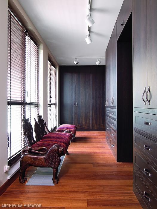06 The dressing room has a lot of black oak wardrobes with leather pulls