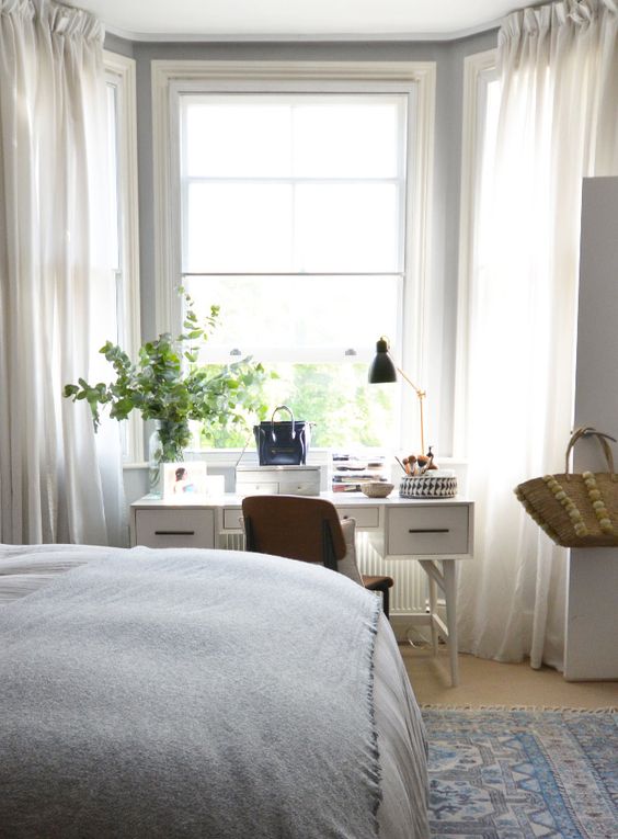serene bedroom with a white desk by the window