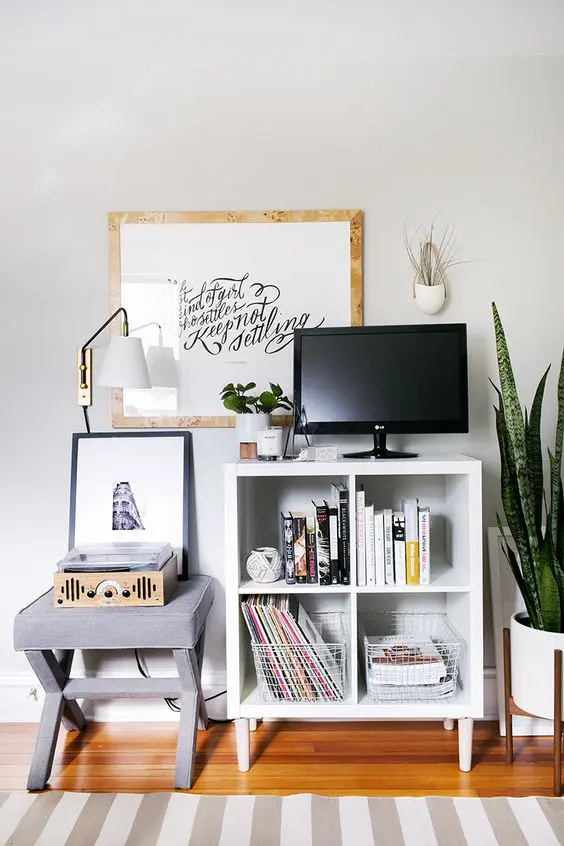 An IKEA Kallax TV console on tall legs to make its usage more comfortable and to add a mid century modern touch to the space