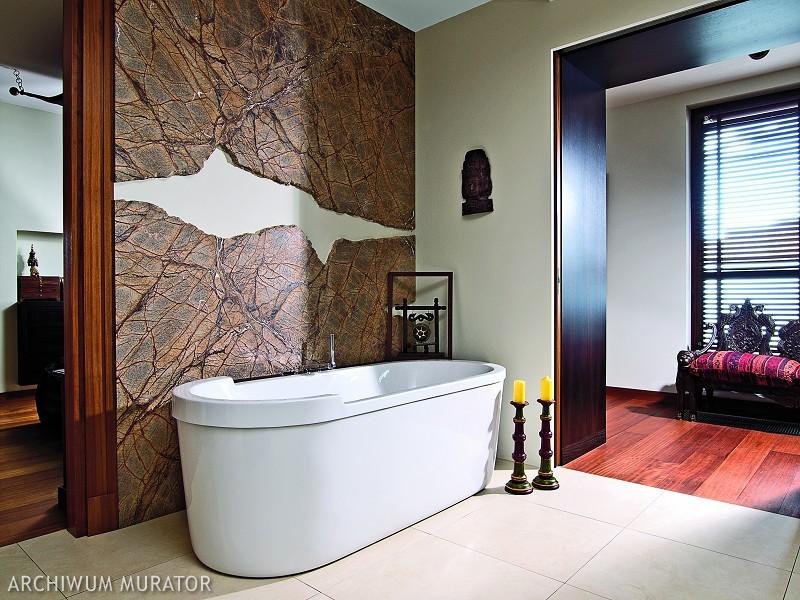 The bathroom is clad with Indian stone