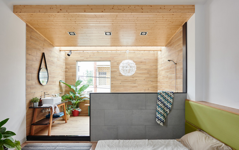 The bedroom opens into the timber clad bathroom