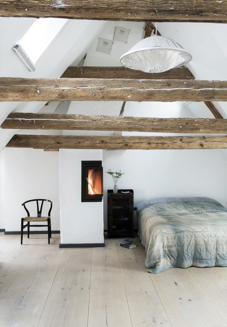 The master bedroom is an attic space with exposed wooden beams, a wood hearth and Dinesen oak floors, very peaceful and relaxing
