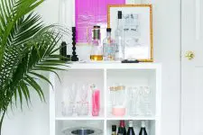 an IKEA Kallax home bar with gilded legs, with decor and all the necessary bar stuff is a perfect idea if you need a bar