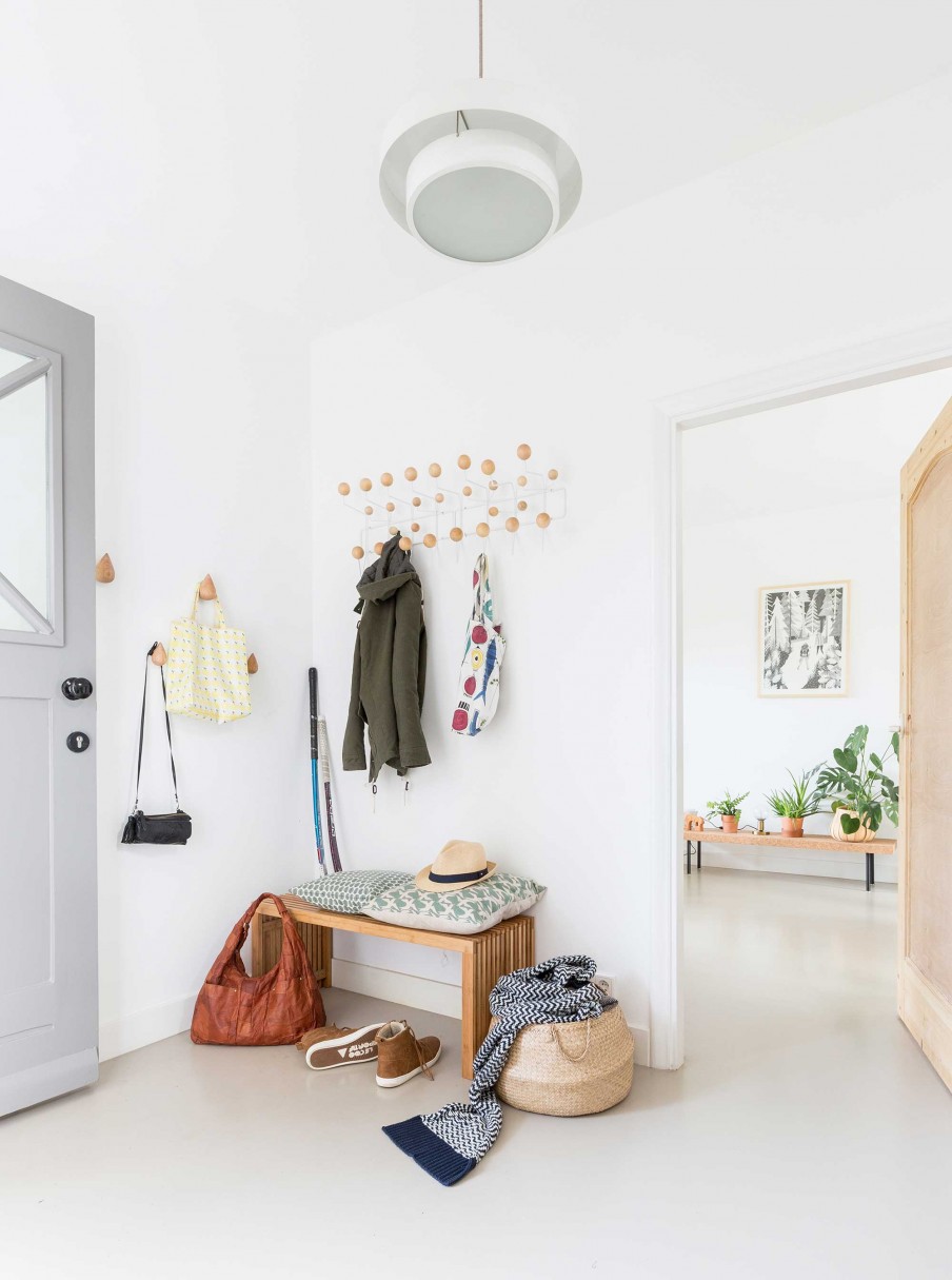 The entryway is Scandinavian, all white with light colored wood touches