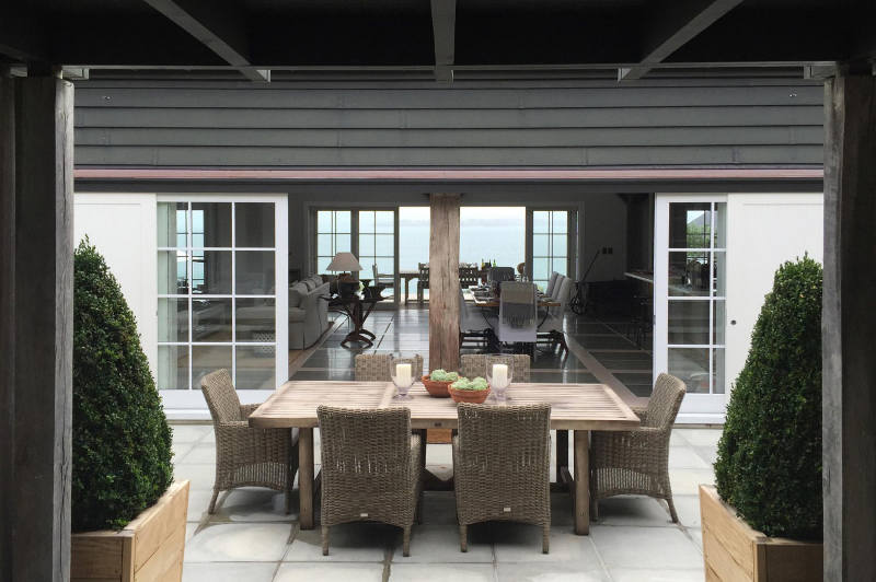 The patio can boast of a cool dining space with woven furniture