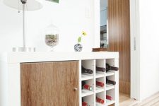 an IKEA Expedit home bar finished with drawers and doors and wine bottle compartments to make storage more effective and comfortable