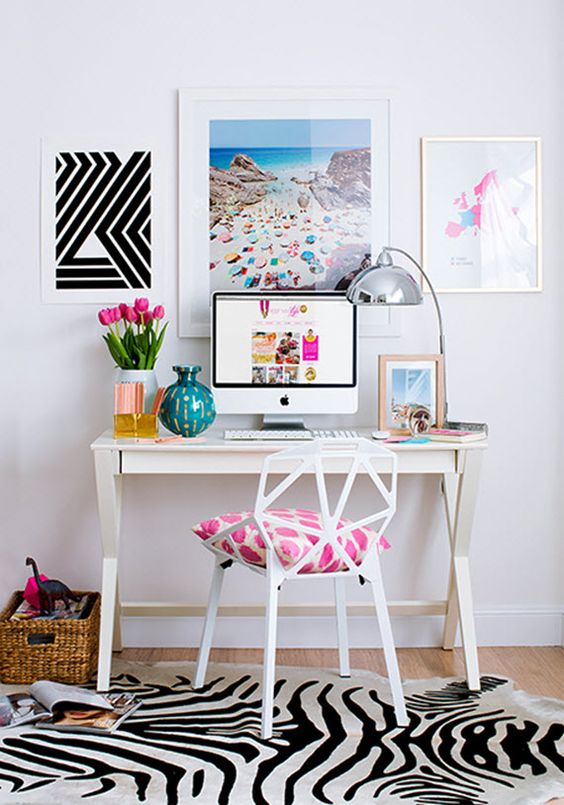 bright girlish study nook with pictures and a small desk