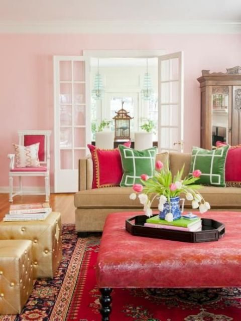 Pink, fuchsia, red and green are grounded by the honeyed tones of hardwoods and a caramel sofa