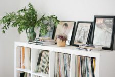 a Kallax unit turned into a media console, for storing all the vinyl and some cool artwork and potted greenery