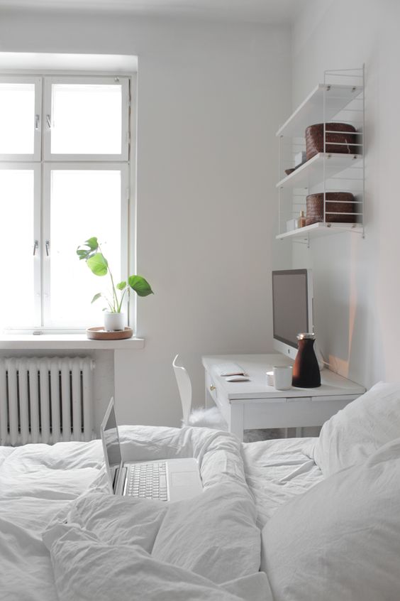 serene white bedroom with a white desk