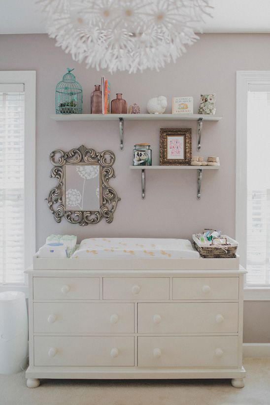 white changing table with storage shelves above it