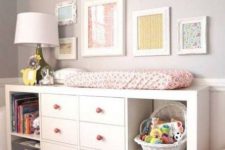 an IKEA Kallax changing table with pink knobs will let you change the diapers and will provide you with a lot of storage space